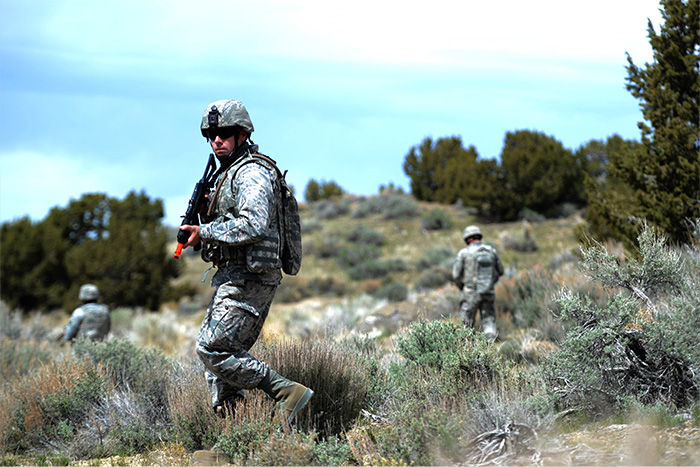 Service members training in a field