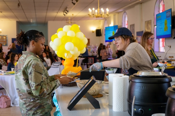 USO serving a meal to a service member