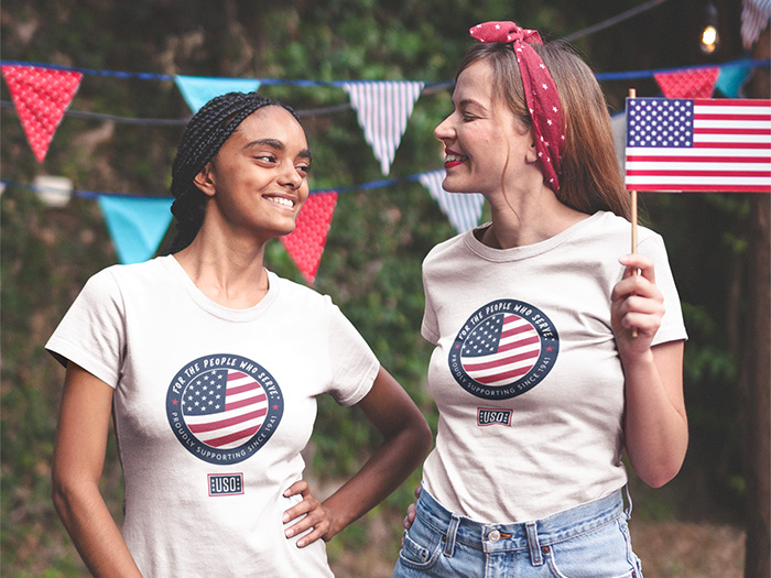 Smiling friends wearing USO T-shirt