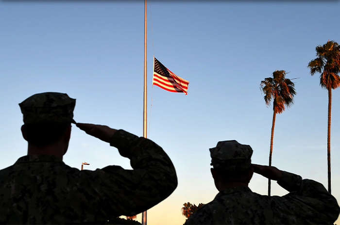 Soldiers saluting the American flag.