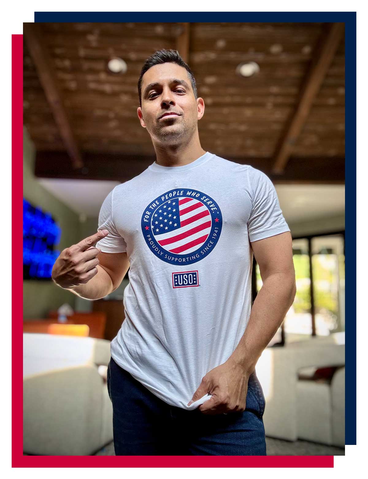 Wilmer Valderrama posing in a USO t-shirt.