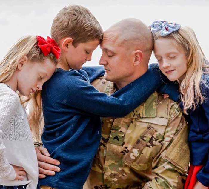 Photo of service member with his three children, including Annalyn M.