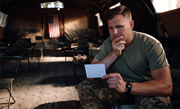 Serviceman reading thank you card