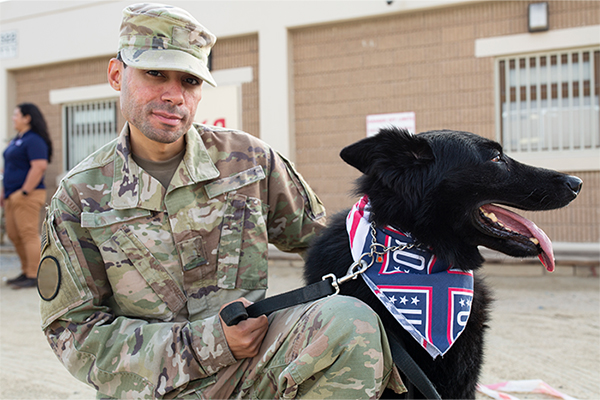 Photo of service member and their dog