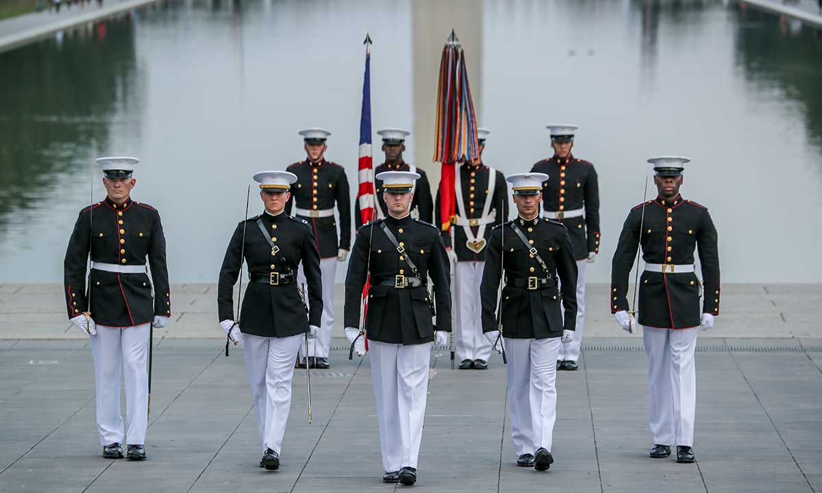 Marines marching with flag