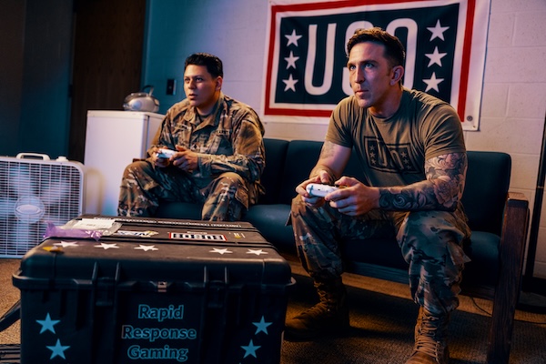 Service members playing video games and card games at USO Centers.