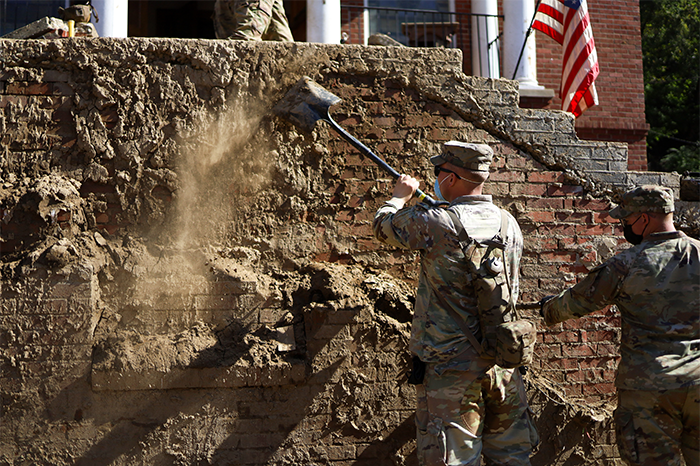 Service members clean mud off a church in North Carolina.