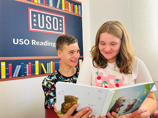 Children read book together through USO Reading Program