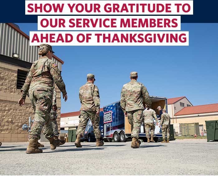 Service members walking toward USO delivery truck.