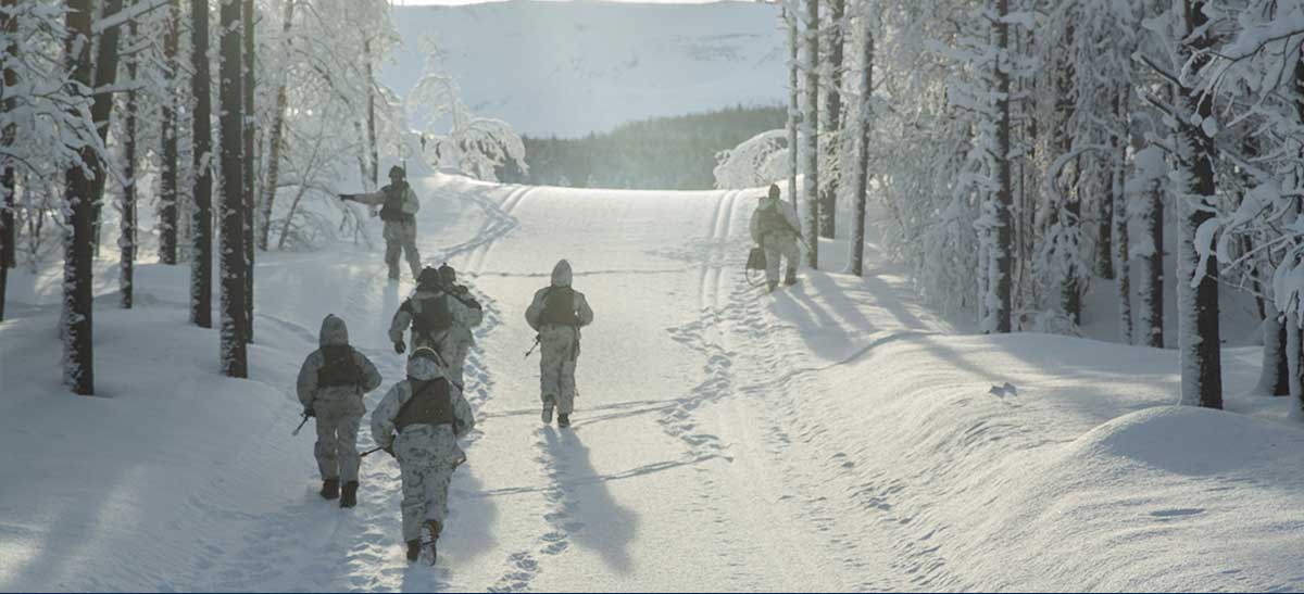 Photo of a a group of service members walking in snow