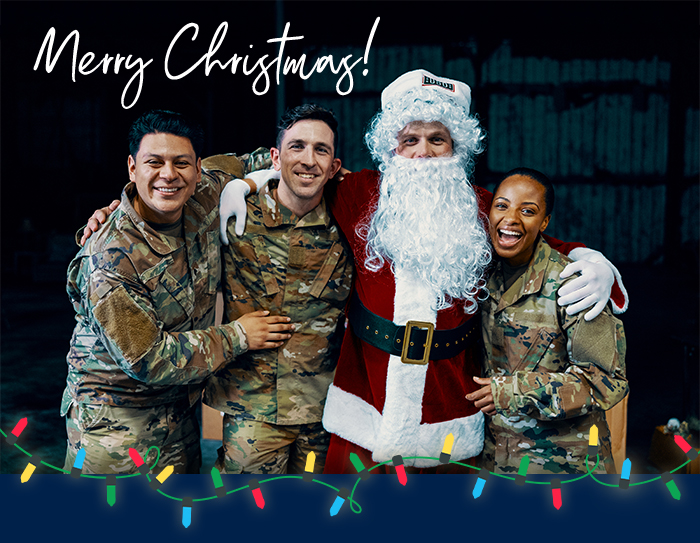 Service members pose with Santa.