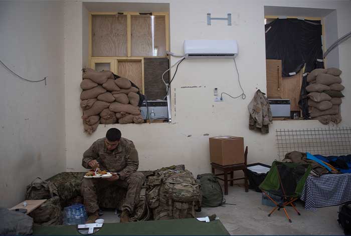 Service member eats alone in barracks.