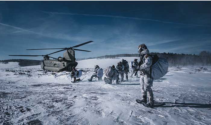 Service members conduct training mission in freezing environment.