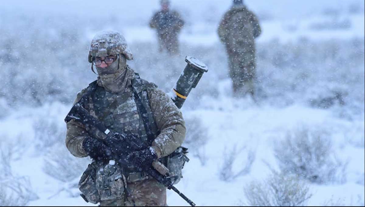 Service member walking through snow storm.