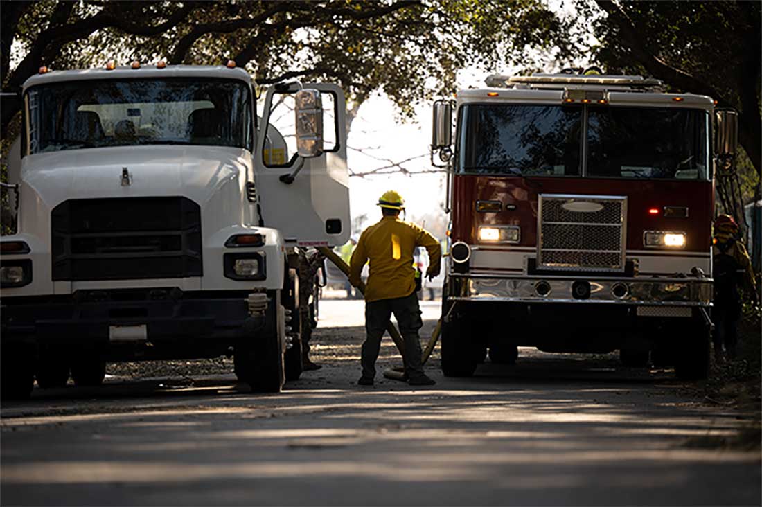 Service members assist in fire suppression efforts against the Eaton Fire in Altadena, California.