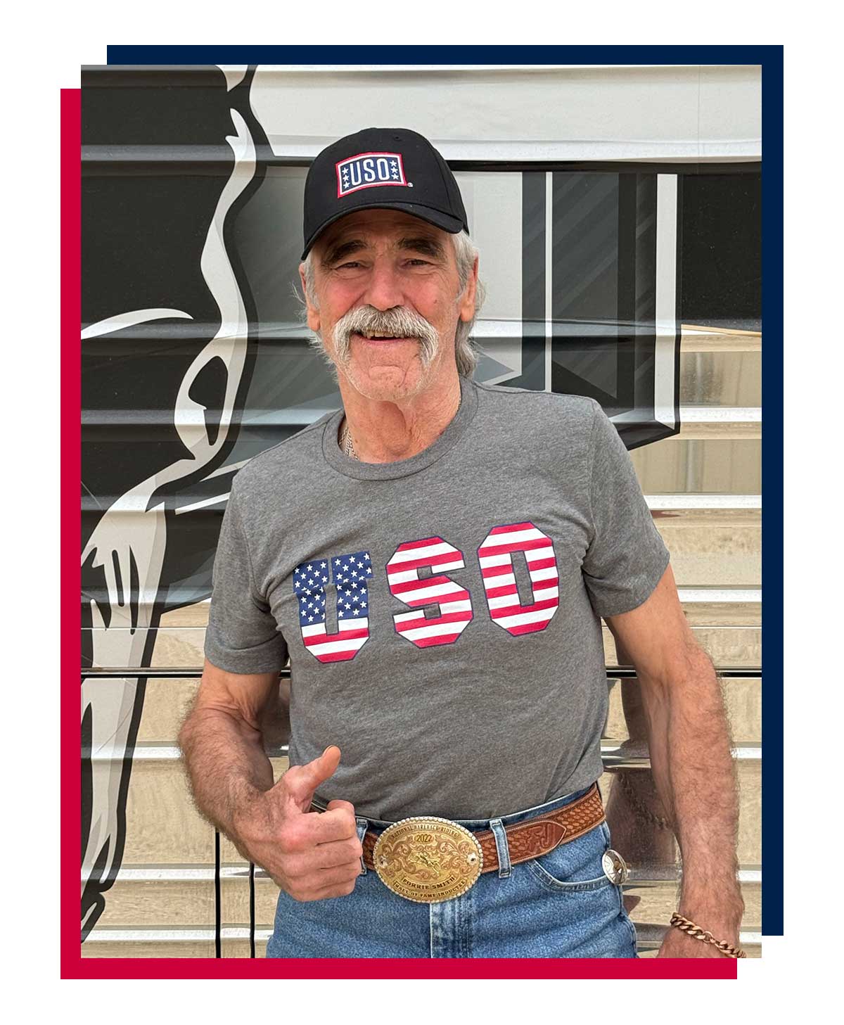 Forrie Smith posing in a USO t-shirt.