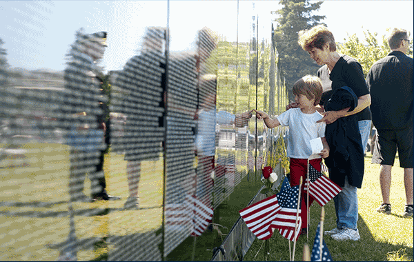 GIF - first image service member at attention in front of memorial, second a family in front of a memorial