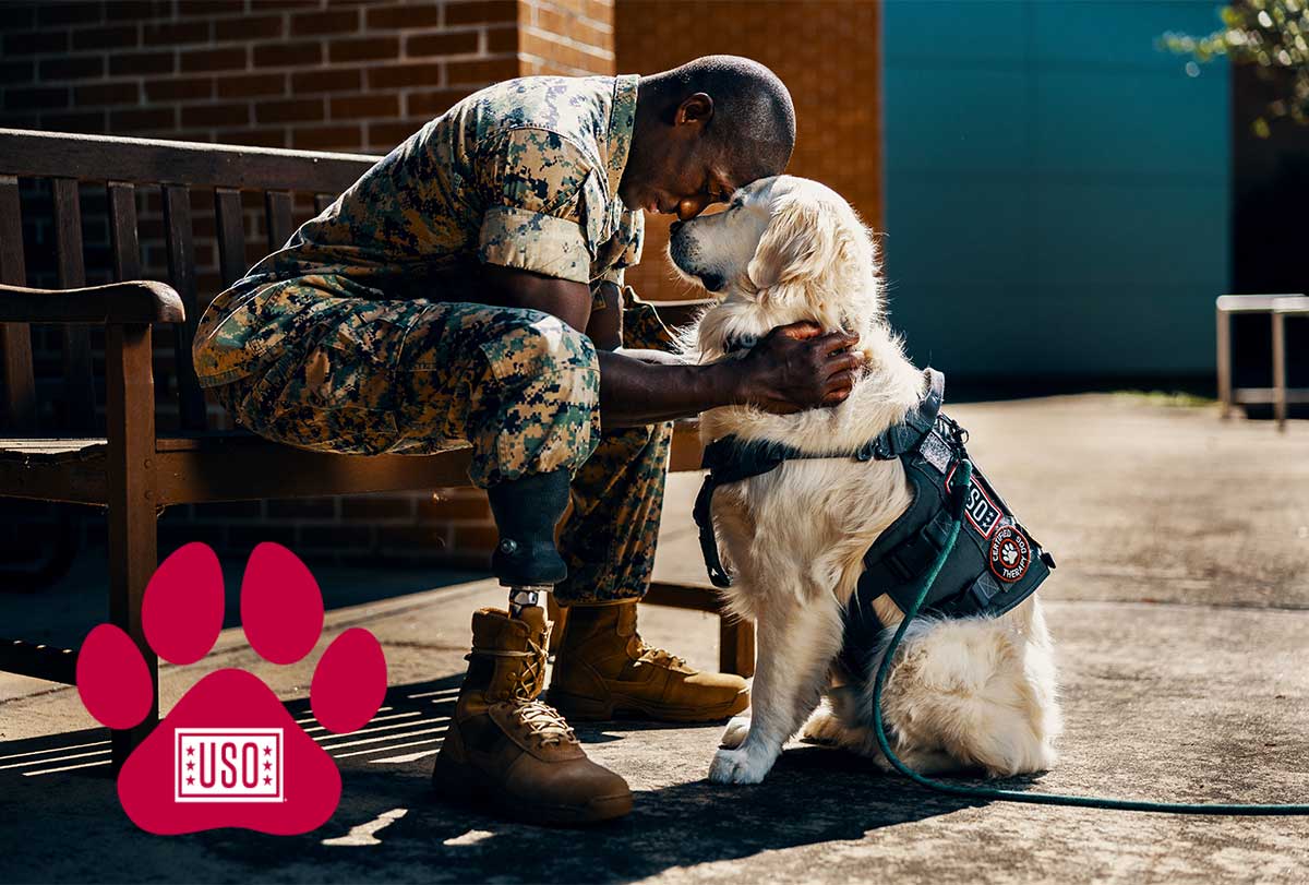 Service member with USO Canine
