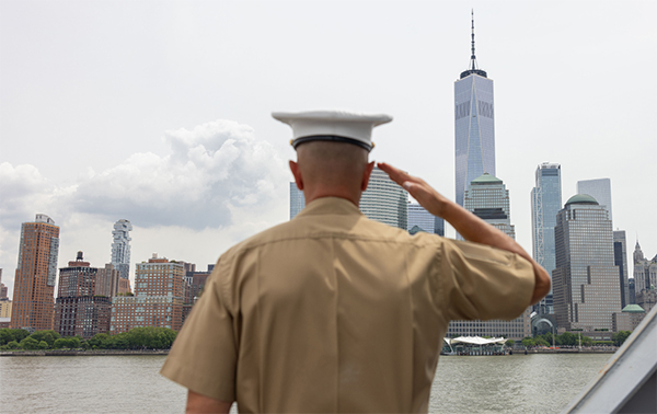 Service member saluting New York City's skyline