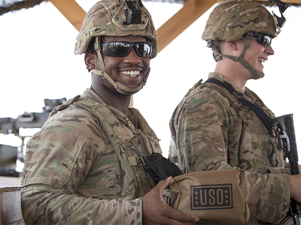 Service member holding USO aid.