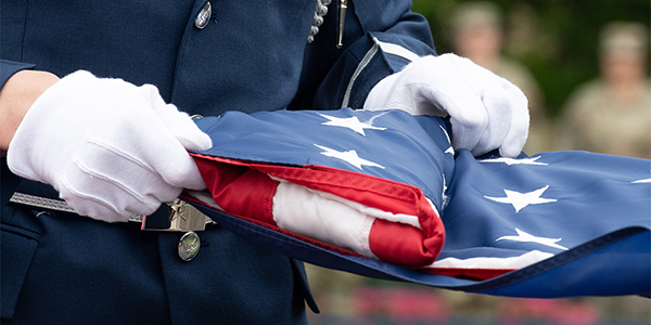 Folded flag in the hands of a service member