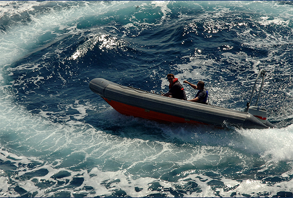 Naval service members working at sea.