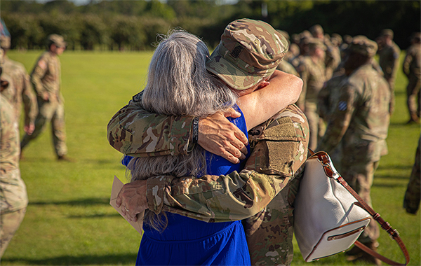 Service member hugging a family member