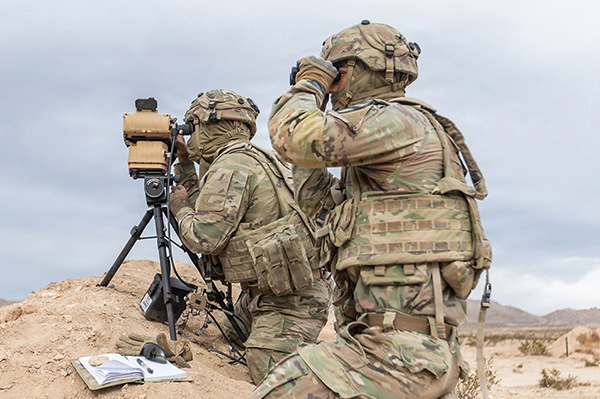 Service members using field equipment