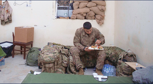 Service member eating on his own