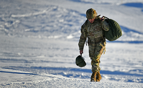 Service member travelling through the snow