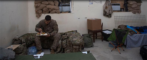 Service member eating alone.