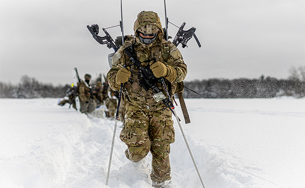 Service members moving through snow